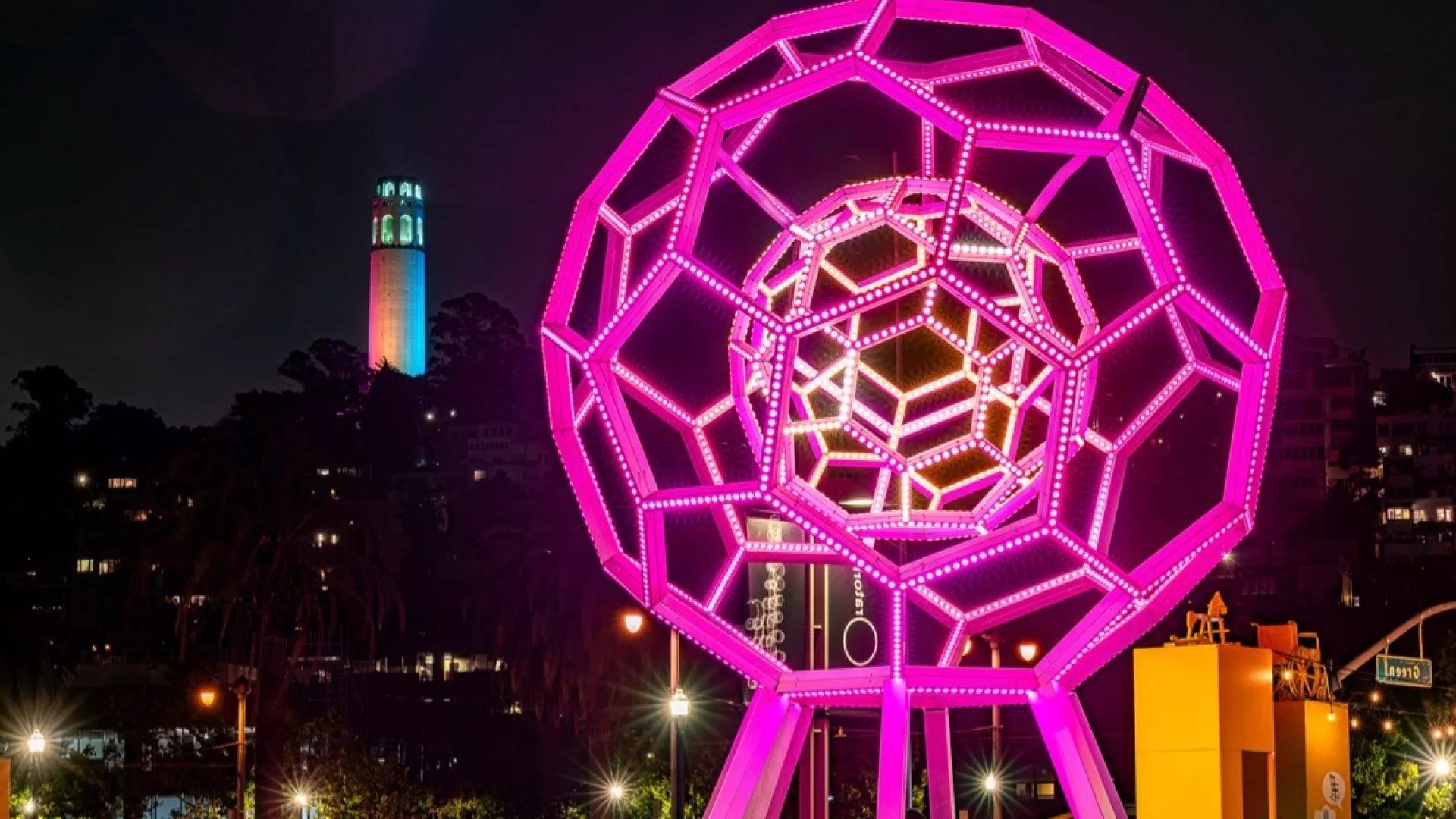 Buckyball glows in the foreground while Coit Tower shines in the distance.