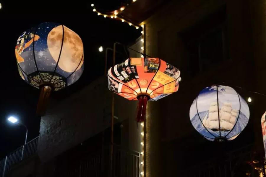Lanterns glow above Chinatown streets.